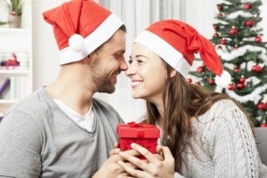 young couple is happy with gift for christmas