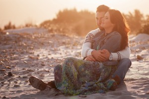 Lovely young couple on the sunset beach, selective focus